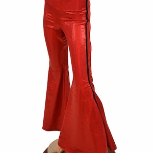 May include: Red flared pants with a black stripe down the side. The pants are made of a shiny, sparkly fabric.