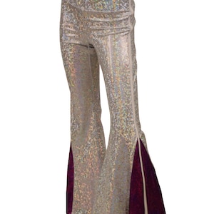 May include: Silver iridescent flared pants with a purple velvet panel on the side and a white zipper detail.