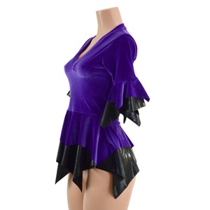 May include: Purple velvet top with a black trim and a ruffled, asymmetrical hem.