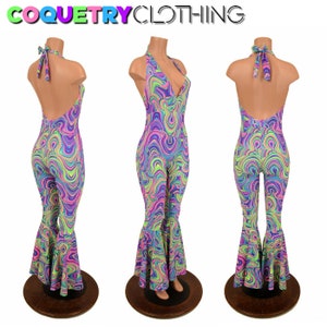 May include: A halter-neck jumpsuit with a vibrant, swirling pattern in shades of purple, blue, green, and pink. The jumpsuit features a flared leg design and is displayed on a mannequin. The text "COQUETRYCLOTHING" is at the top.