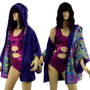 May include: Two mannequins wearing a shiny magenta bodysuit with cutouts and a hooded, plush, dark blue robe. The robe's interior features a colorful, swirling pattern with green, blue, and pink hues. The outfits are displayed against a white background.