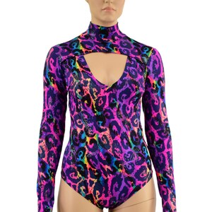 May include: A long-sleeved bodysuit with a high neck and a keyhole cutout at the neckline. The bodysuit is made of a stretchy fabric and features a colorful leopard print pattern in shades of pink, purple, blue, and green.