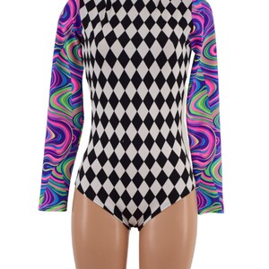 May include: A long-sleeved bodysuit with a high neck. The body of the garment features a black and white diamond pattern. The sleeves have a colorful, swirled design in shades of purple, green, and blue.