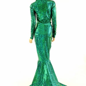 May include: A long, green mermaid-style dress with a sparkly, iridescent finish. The dress has a fitted bodice and a flowing skirt with a mermaid tail.