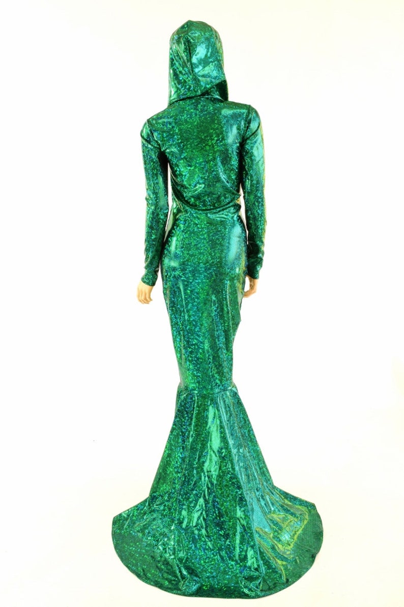 May include: A long, green mermaid-style dress with a sparkly, iridescent finish. The dress has a fitted bodice and a flowing skirt with a mermaid tail.