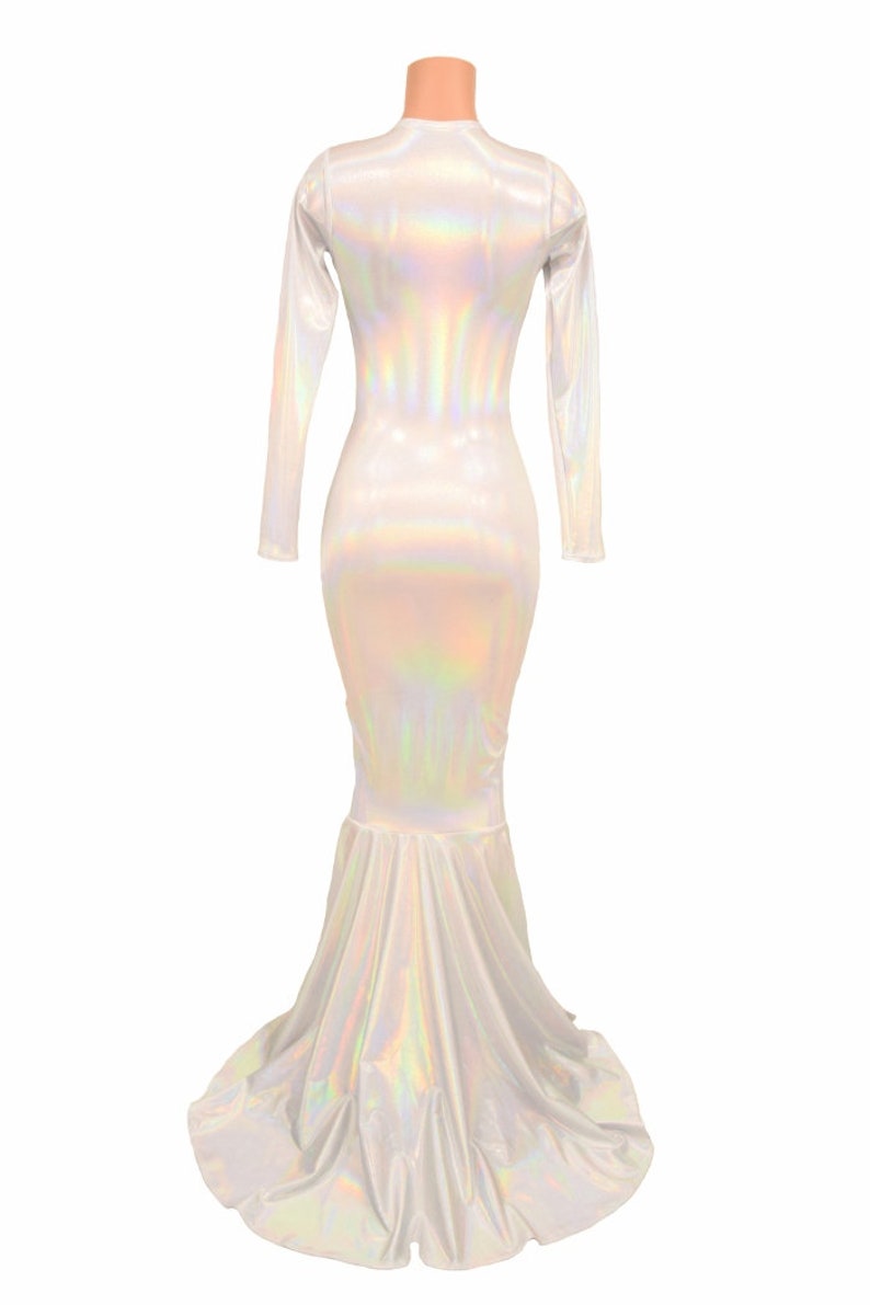 May include: A long-sleeved, iridescent white mermaid-style dress with a fitted bodice and a flowing skirt.