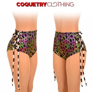 May include: High-waisted black shorts with a colorful, iridescent, abstract pattern. The shorts have white and black striped ties that lace up the sides.