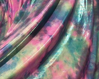 May include: Close-up of iridescent fabric with a tie-dye pattern in shades of pink, green, and blue.
