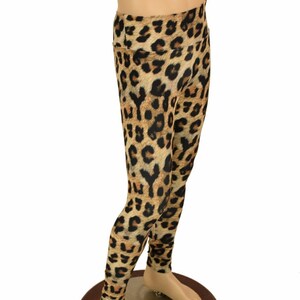 May include: Leopard print leggings in brown and black. The leggings are on a mannequin.