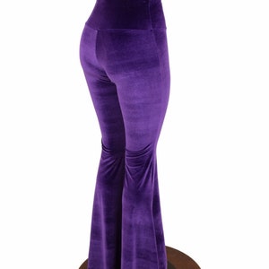 May include: Purple velvet bell bottom pants with a high waist.