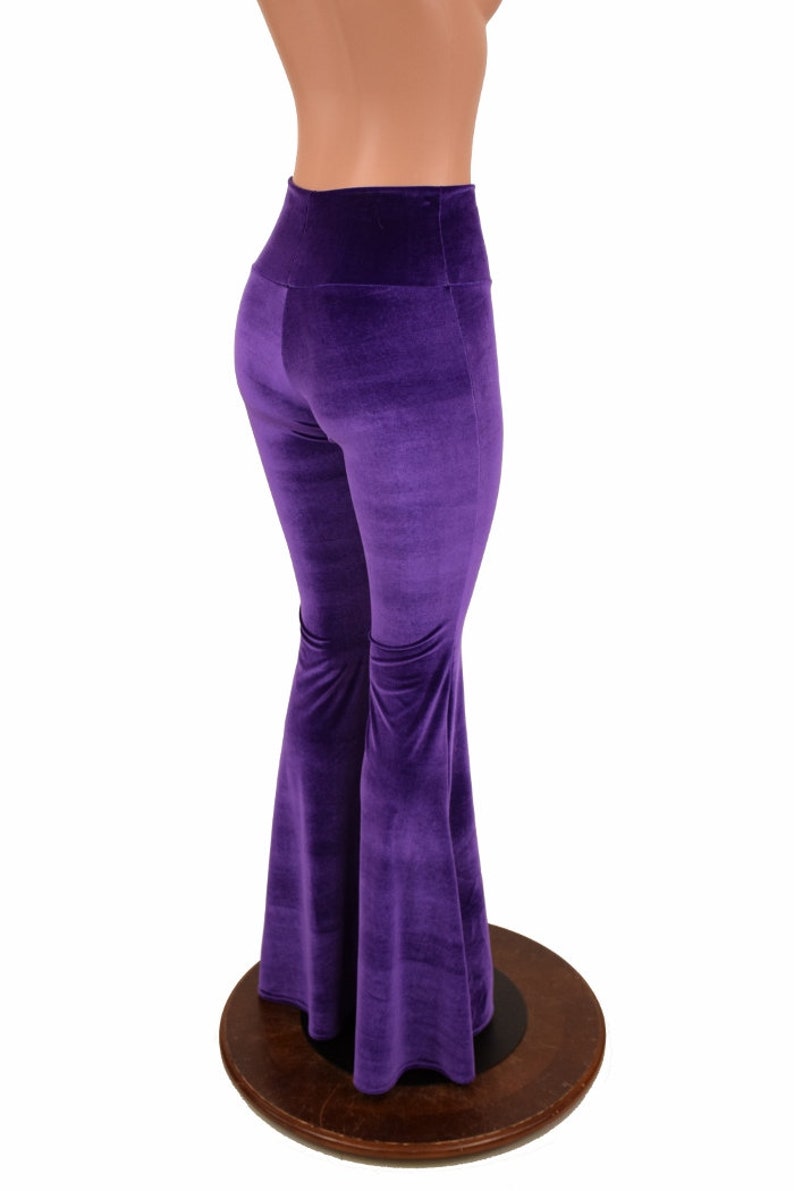 May include: Purple velvet bell bottom pants with a high waist.