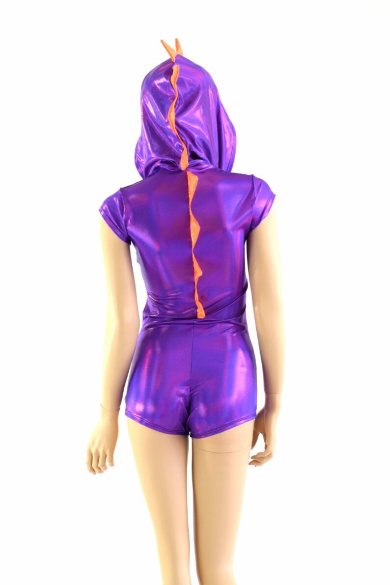 May include: Purple and orange shiny bodysuit with a short sleeve and a hood. The bodysuit has a tail that looks like a dinosaur spine.