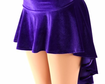 May include: A purple velvet mini skirt with a high-low hemline. The skirt has a fitted waistband and a flared, ruffled hem.