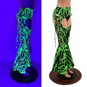 May include: Black and green pants with a lightning bolt pattern. The pants have a lace-up detail on the side and a flared leg.
