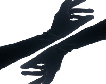 May include: A pair of long black velvet gloves. The gloves are shown with the fingers extended and the palms facing outward.