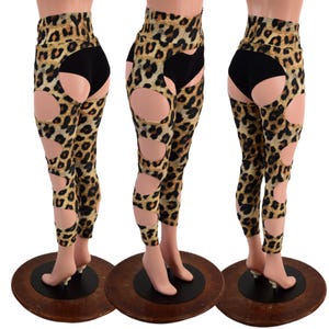 May include: Leopard print leggings with cutouts on the thighs and sides. The leggings are high-waisted and have a black waistband.
