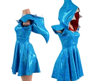 May include: A bright blue holographic dress featuring a shark-themed hood with a red interior lining and white triangular teeth accents. The garment has short sleeves, a fitted bodice, and a flared skirt, showcasing a shimmering, reflective finish.