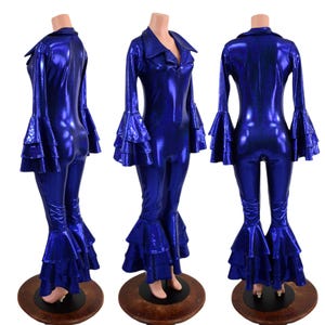 May include: A blue metallic jumpsuit with long sleeves and a wide collar. The sleeves and legs have multiple layers of ruffles. The jumpsuit is on a mannequin.