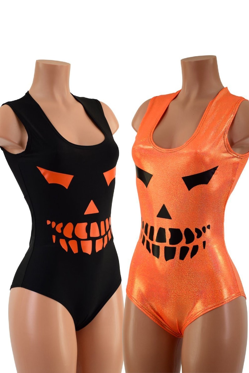 May include: Two sleeveless leotards with a jack-o'-lantern face design. One leotard is black with an orange jack-o'-lantern face. The other leotard is orange with a black jack-o'-lantern face.