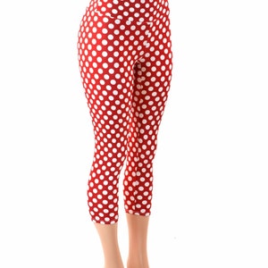 May include: Red and white polka dot capri leggings. The leggings are made of a stretchy, comfortable fabric and have a high waist.