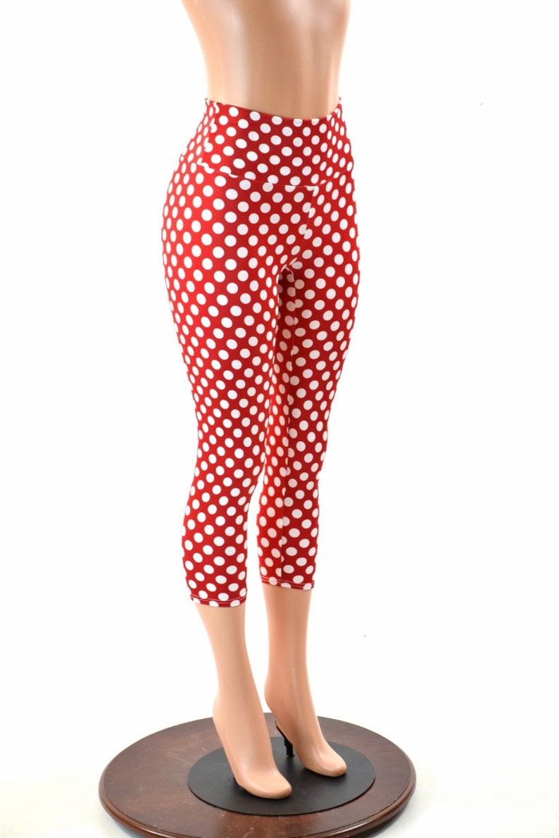 May include: Red and white polka dot capri leggings. The leggings are made of a stretchy, comfortable fabric and have a high waist.