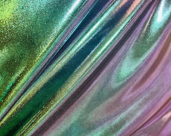 May include: Close-up of iridescent fabric with a green, blue, and purple color gradient. The fabric has a smooth, shiny texture.