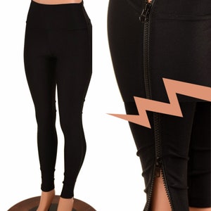 May include: Black leggings with a high waist and zippers along the outer seams. The leggings are displayed on a mannequin, showcasing the sleek, form-fitting design. The zippers add a stylish detail to the otherwise simple design.