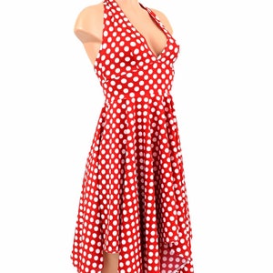 May include: A red and white polka dot halter dress with a v-neckline and a high-low hemline.