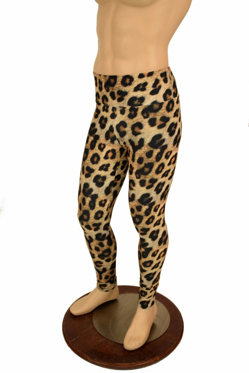 May include: Leopard print leggings in brown, black, and orange. The leggings are on a mannequin.