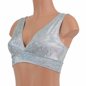 May include: A silver iridescent crop top with a deep V-neckline and a fitted silhouette.