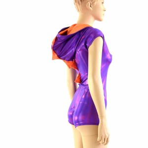 May include: A purple and orange hooded leotard with a shiny, iridescent finish. The leotard has short sleeves and a fitted silhouette.