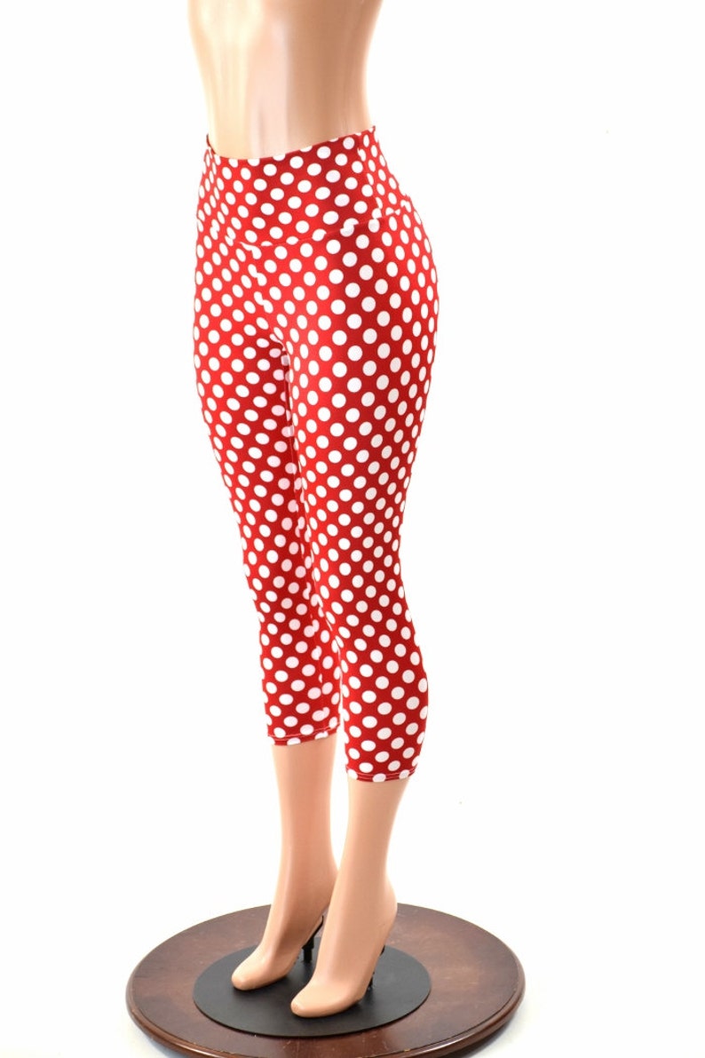 May include: Red and white polka dot leggings with a high waist. The leggings are cropped and end just below the knee.