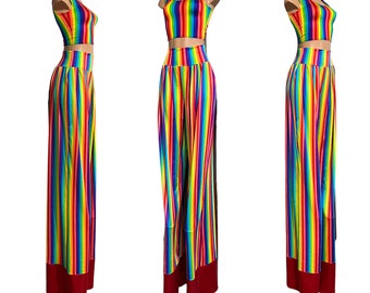 May include: A two-piece outfit featuring a rainbow striped crop top and matching wide-leg trousers. The trousers have a red trim at the bottom.