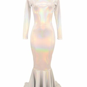May include: A white iridescent mermaid-style gown with long sleeves and a fitted bodice. The gown has a flowing skirt with a mermaid tail design.
