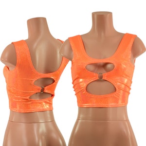 May include: Orange crop top with a cut-out design and a metal ring detail. The top is sleeveless and has a scoop neck.