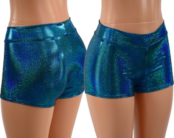 May include: Teal iridescent shorts with a high waist and a stretchy fabric. The shorts are made of a shiny material and have a subtle shimmer.