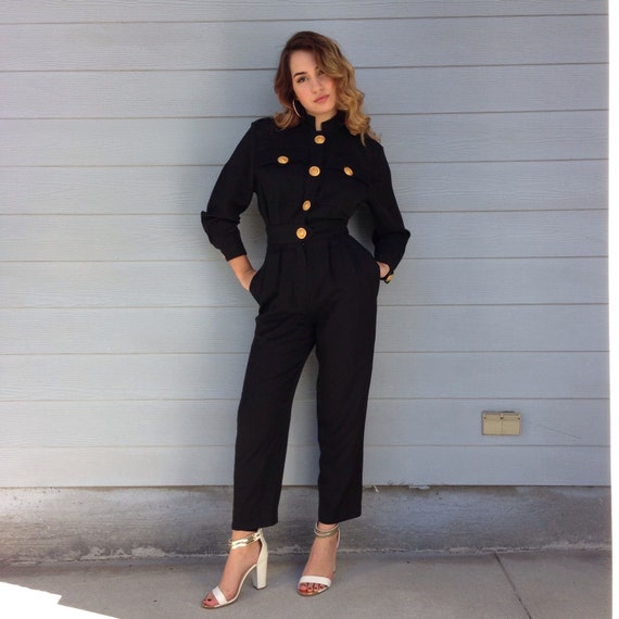 black jumpsuit with gold buttons