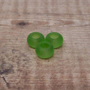 May include: Three green earbud tips for headphones. The tips are made of a soft, flexible material and are designed to fit comfortably in the ear.