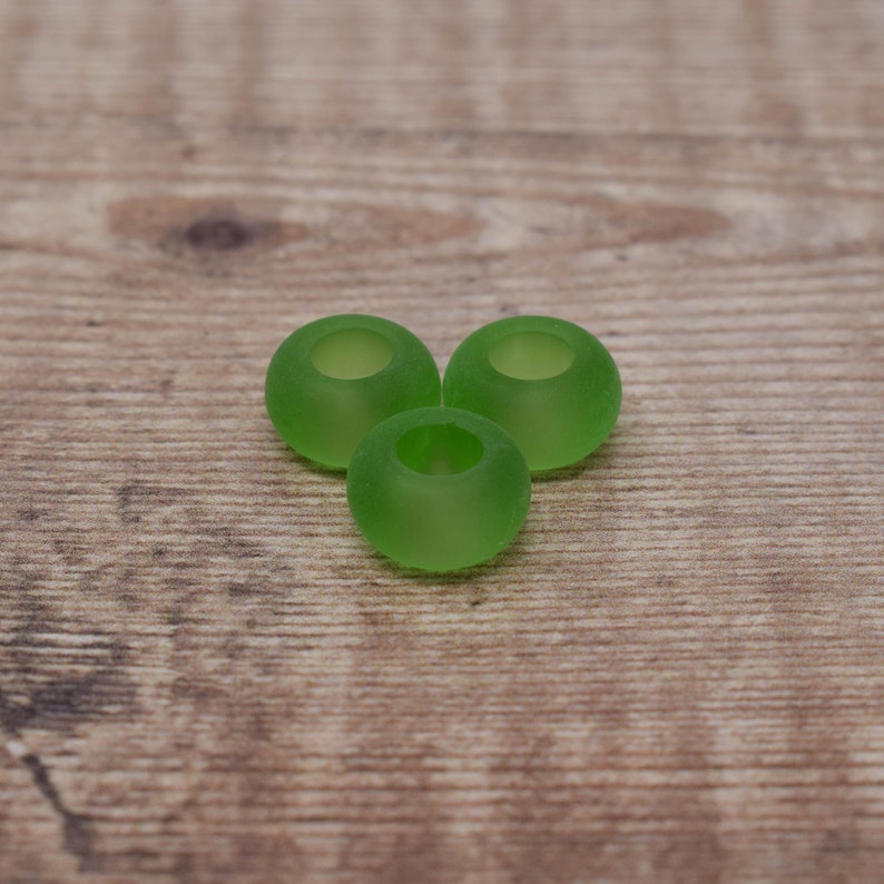 May include: Three green earbud tips for headphones. The tips are made of a soft, flexible material and are designed to fit comfortably in the ear.