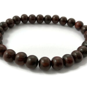 May include: A dark brown wooden beaded bracelet with round beads.