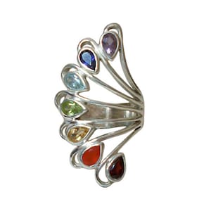 May include: Silver ring with seven colorful gemstones arranged in a fan shape. The gemstones are amethyst, sapphire, aquamarine, peridot, citrine, carnelian, and garnet.