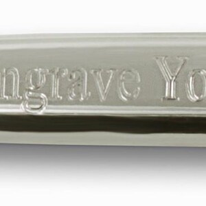 May include: A polished silver-toned metal tie bar with a smooth, reflective surface. The front of the tie bar features the engraved text "Free Engrave Your Name Here" in a clear, sans-serif font, centered along the length of the accessory.