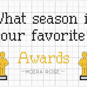 May include: A black and white cross-stitch design with the text "What season is your favorite?" and the words "Awards" in gold. The design also features two gold award statues.