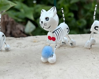 Skeleton Cat with Light Blue Ball