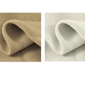 May include: Two fabric swatches, one in a light beige color and the other in a light gray color. Both swatches are made of a woven linen fabric with a textured surface.