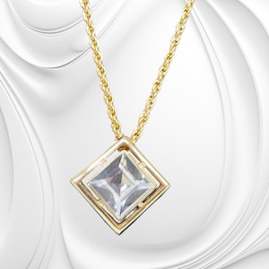 May include: A gold-toned necklace featuring a square pendant with a clear, faceted center stone. The pendant is set within a square frame, and the chain has a twisted rope design. The jewelry is displayed against a white background.