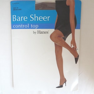 May include: A packet of Bare Sheer control top tights by Hanes in a brown skin tone. The packaging has a blue top section with the words "Sandalfoot" and "SIZE: EF BROWN SKIN". A woman is wearing the tights in the image.