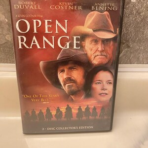 May include: DVD case for the movie "Open Range" featuring Robert Duvall, Kevin Costner, and Annette Bening. The cover has a red and brown background with images of the actors and cowboys on horseback. The text "2-DISC COLLECTOR'S EDITION" is at the bottom.