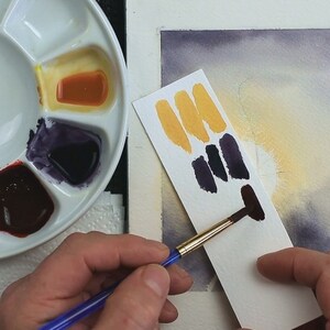 In this photo Paul is showing how he tests his black mix to ensure it is the tone he wants it for painting the silhouette.