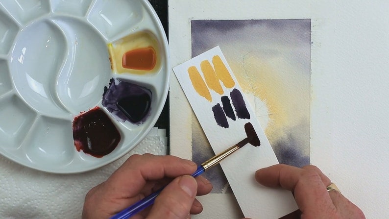 In this photo Paul is showing how he tests his black mix to ensure it is the tone he wants it for painting the silhouette.